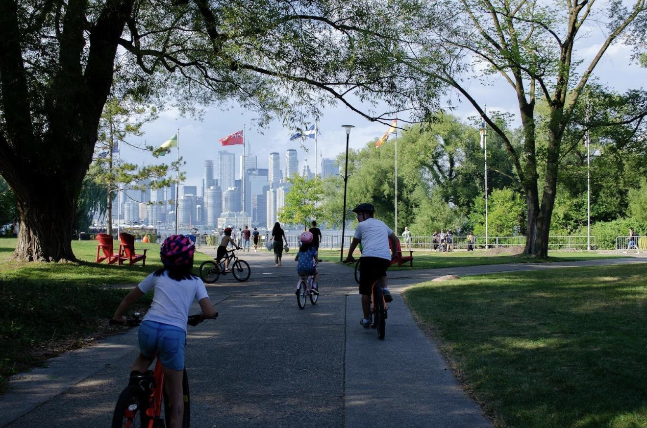 Family biking in the summer in Toronto Park